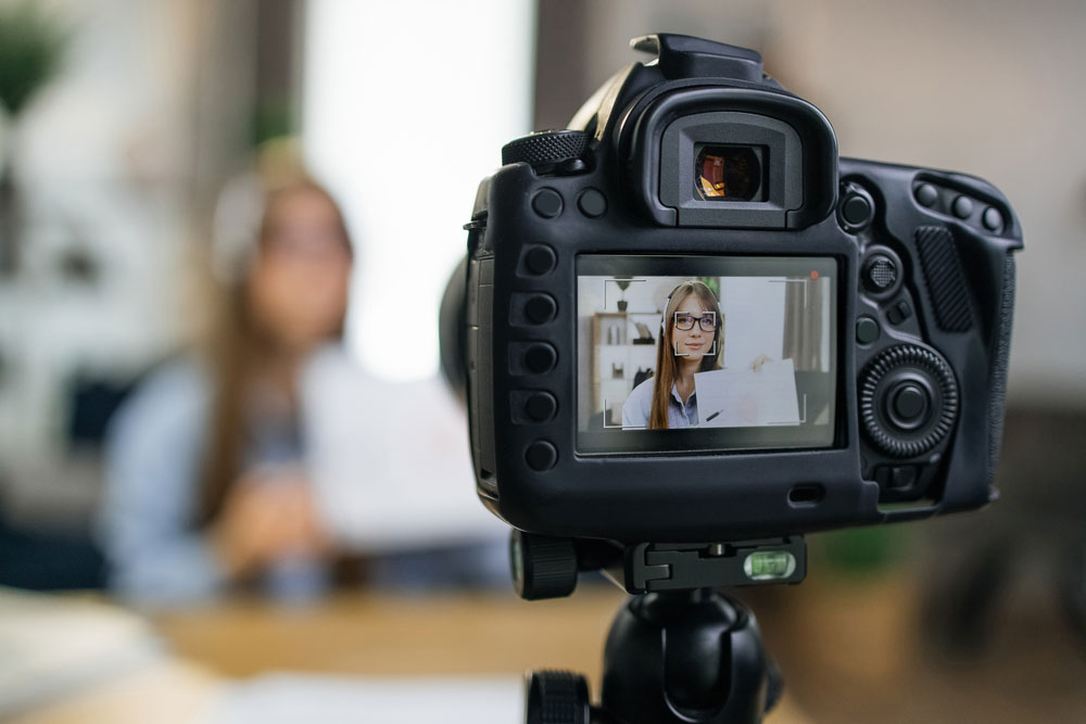 woman on camera viewfinder | Personal touch on marketing videos | The Advisor Authority - Erin Botsford